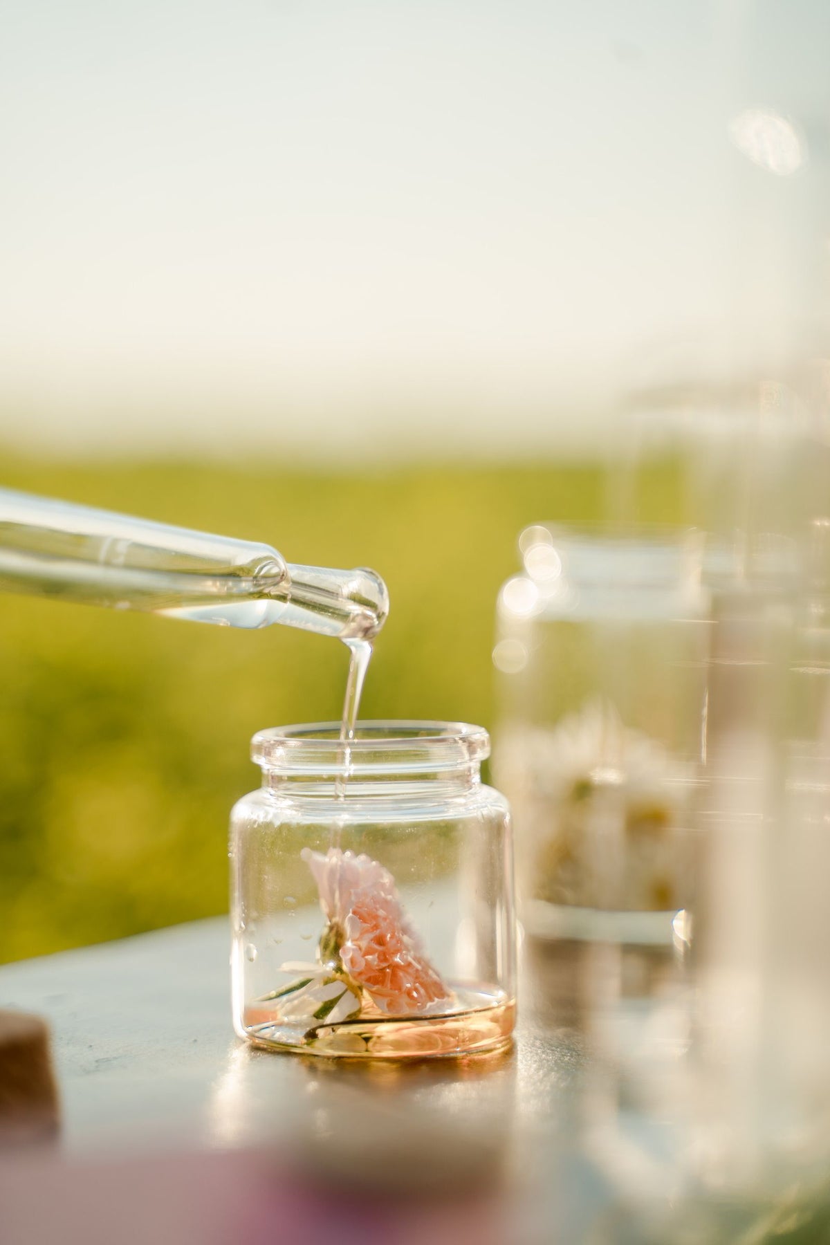 Oil being added to a glass jar