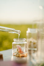 Argan oil poured into a glass jar